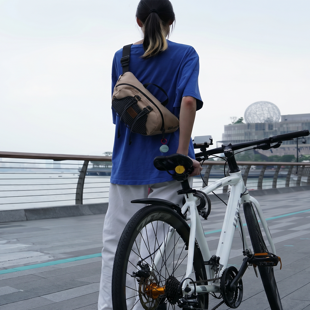 Person with bicycle on scenic boardwalk using Roam Smart Tracker for bike tracking - GPS tracker for bikes and outdoor activities